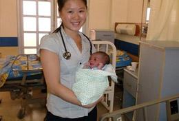 Volunteer Jamaica A high school Public Health volunteer holds a baby in the maternity department of a hospital in Jamaica.