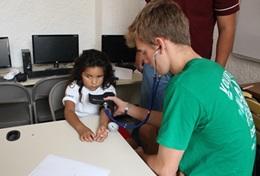 Volunteer Mexico A Public Health volunteer in Mexico gains experience measuring blood pressure during his short-term high school internship.