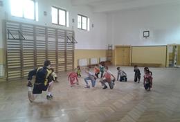 Volunteer Sports A Football volunteer leads a sports team in Romania through a stretching routine before they start their practice.