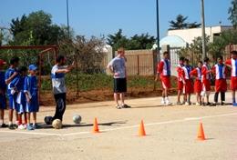 Volunteer Morocco Local school children work on a football drill with a volunteer at our Multi-sports placement in Morocco.