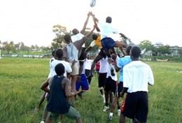 Volunteer Ghana Sports players catch the ball during a line-out in a rugby match at our volunteer Rugby placement in Ghana.