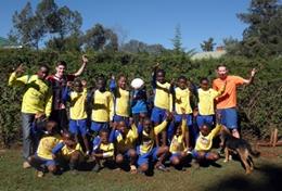 Volunteer Kenya A local football team poses together before a sports lesson at our volunteer School Sports placement in Kenya.
