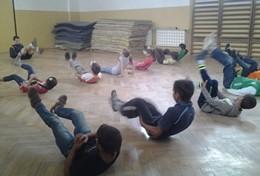 Volunteer Sports A School Sports volunteer leads a stretching class during a physical education lesson with school children in Romania.