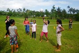 Volunteer Sports A School Sports volunteer works with a group of school children during a physical education lesson in Samoa.