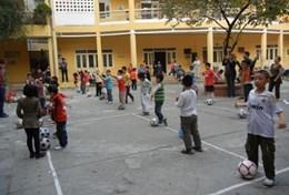 Volunteer Vietnam A Sports volunteer coaches a team of school students during a football lesson in Vietnam.