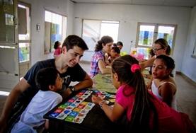 Volunteer Teaching A Teaching volunteer in Argentina plays a fun educational game with school children to help improve their English skills.