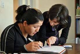 Volunteer Bolivia A Teaching volunteer gives a one-on-one English lesson to a local student at a school in Bolivia.