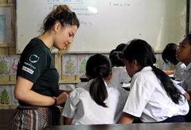 Volunteer Cambodia A Teaching volunteer explains an English activity to school children during a lesson in Cambodia.