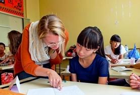 Volunteer Mongolia A volunteer works through an English language exercise with a school student at our Teaching placement in Mongolia.