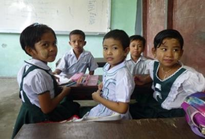 Volunteer Myanmar School children sit at their desk together during an English lesson at our volunteer Teaching placement in Myanmar.