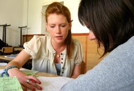 Volunteer Teaching Teaching volunteers in Romania work together on a lesson plan to teach English to children at a local school.