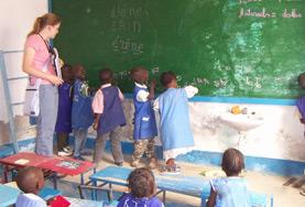 Volunteer Senegal School children in Senegal work together to solve a problem on the blackboard at our volunteer Teaching placement in Senegal.
